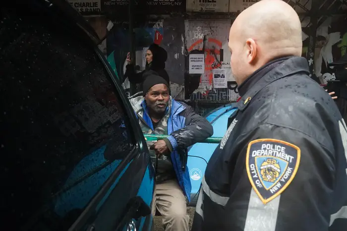 A police officer speaks to a homeless man in the East Village before his tent and belongings were cleared out by the sanitation department in April. Police officers have been directed to transport those believed to be mentally ill to area hospitals.